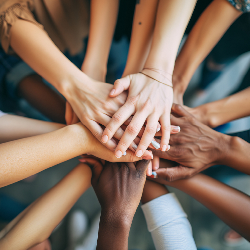 overview shot of hands stacked on top of each other showing teamwork